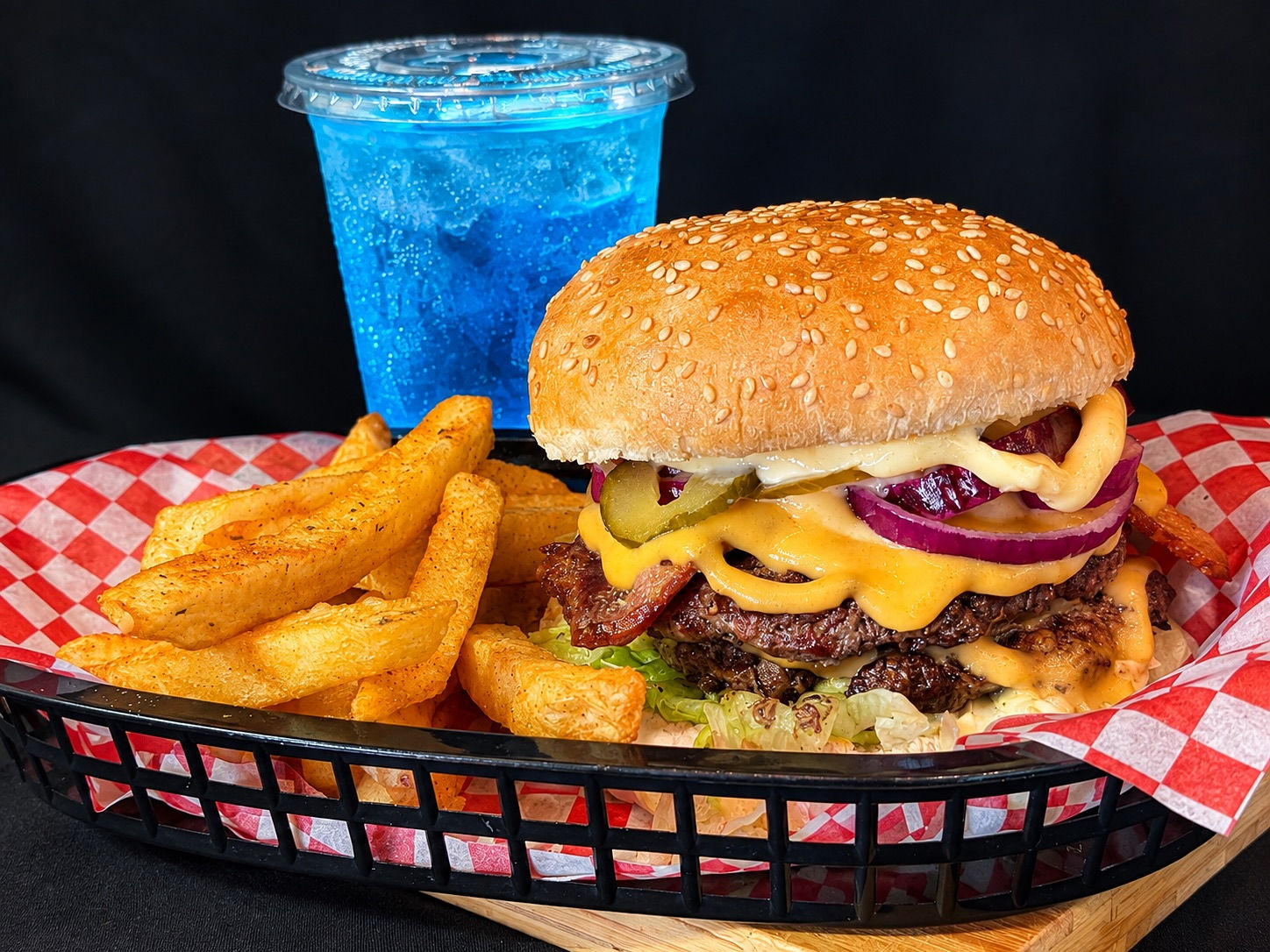 Mega Burger flame-grilled double cheeseburger with melted cheddar, bacon, pickles and red onion, served with thick-cut chips